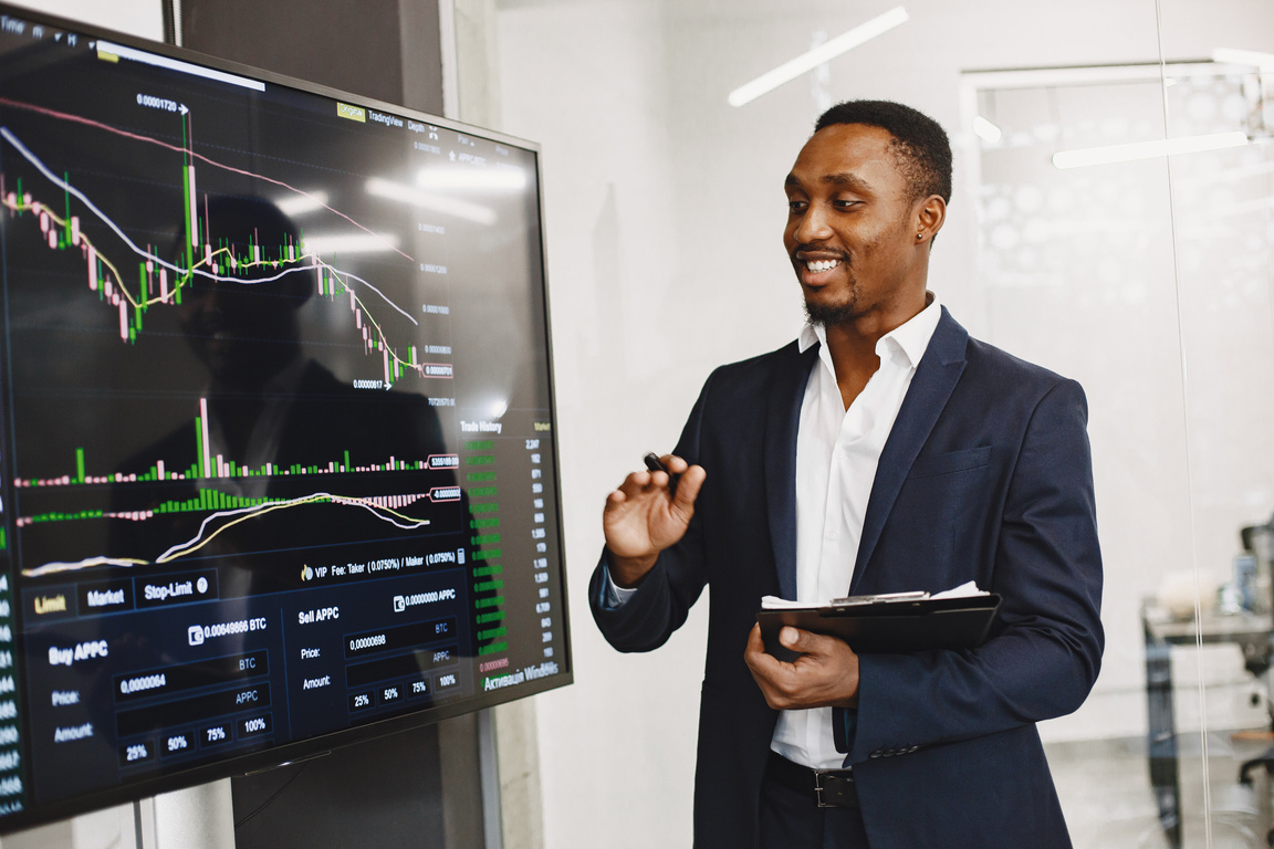 A professional explaining data on a large screen