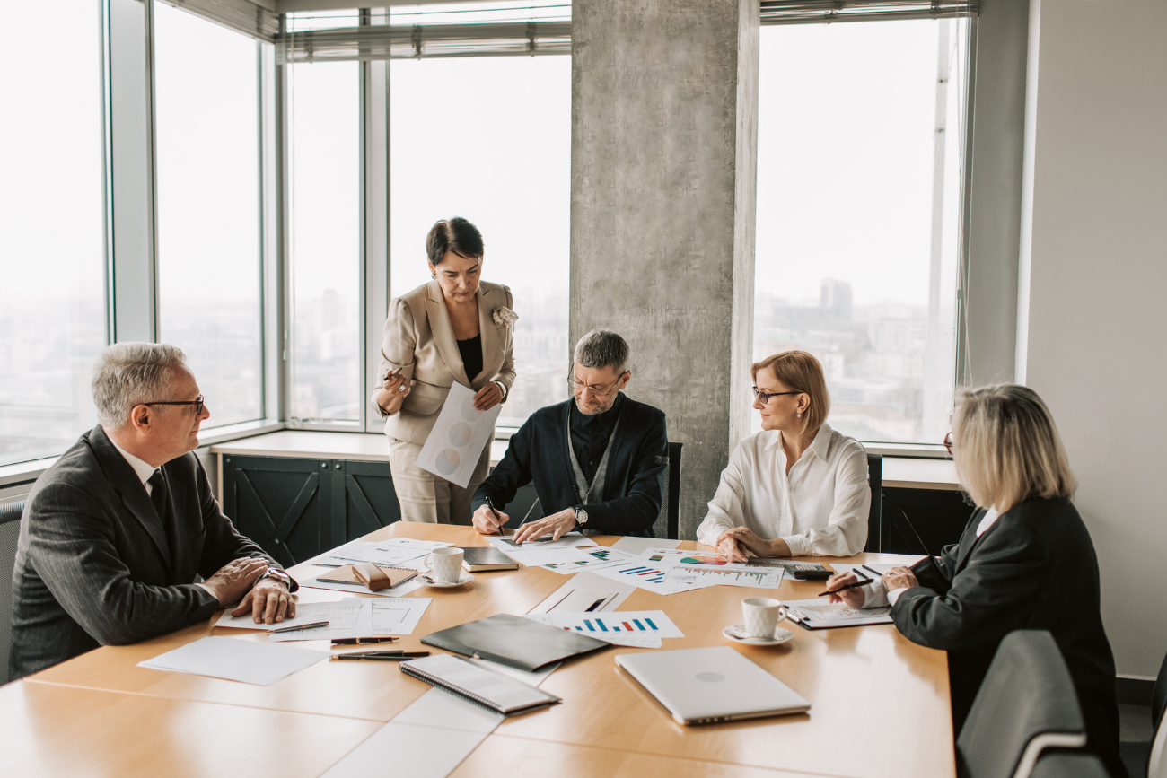 A business team reviewing documents in a boardroom
